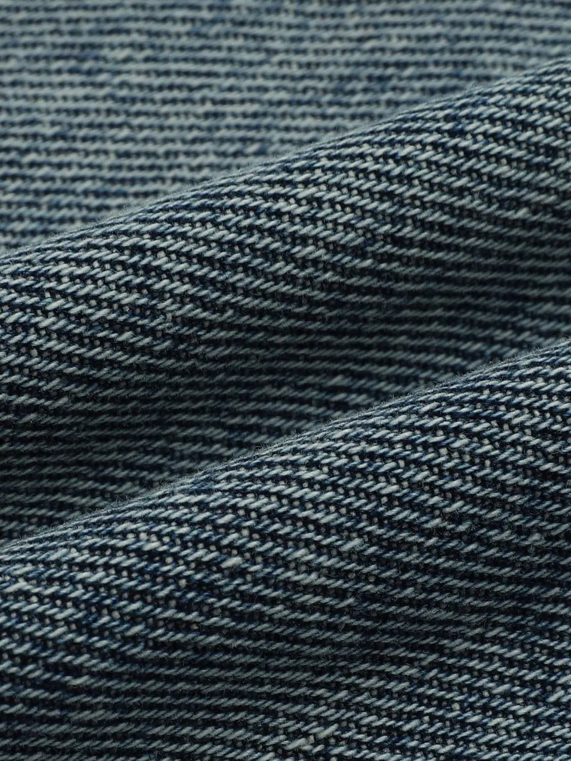 Relaxed high-rise wide-leg Capri cotton jeans fabric close-up in blue denim