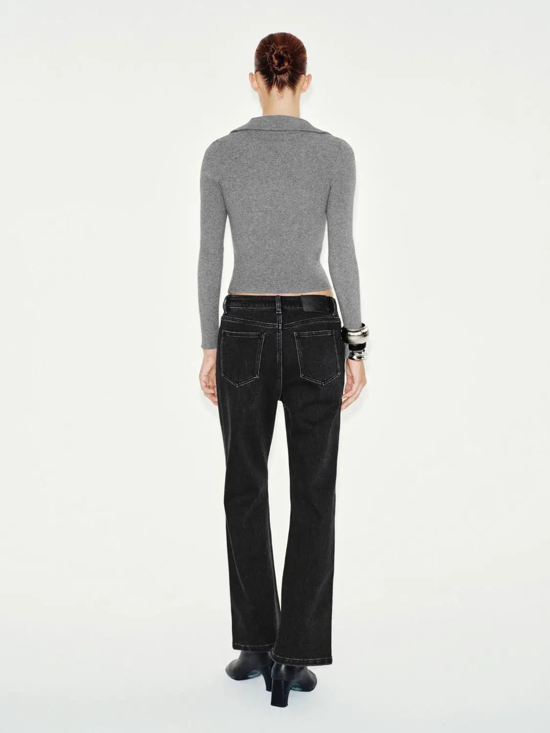 Jeans in black denim with white contrast stitching, back view of model