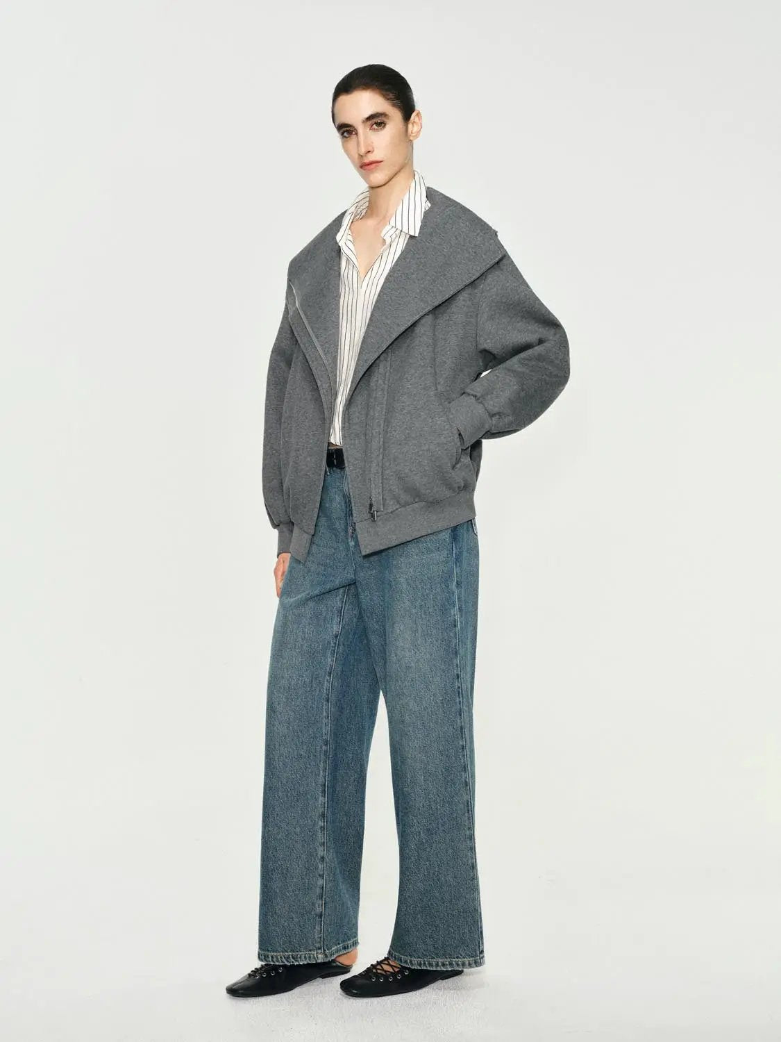 Mid-rise medium-wash cotton wide-leg jeans on a model.