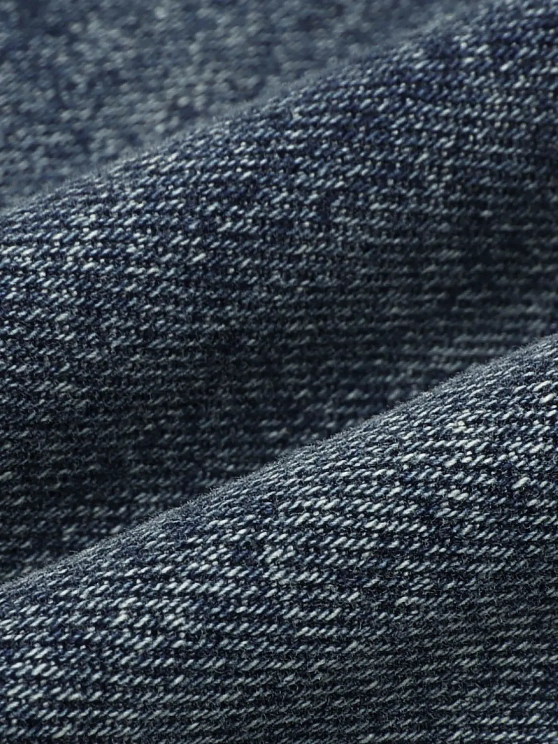 Jeans by Urban Revivo Fashion in dark indigo denim fabric close-up.