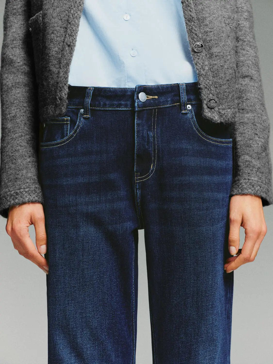 Mid-rise cotton-blend jeans in dark blue denim with contrast stitching and front pockets.