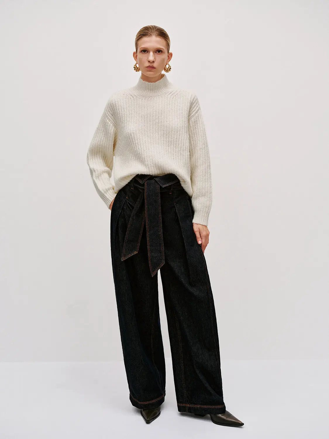 High-neck cream knitted T-shirt by Urban Revivo Fashion; model wears dark denim wide-leg pants.