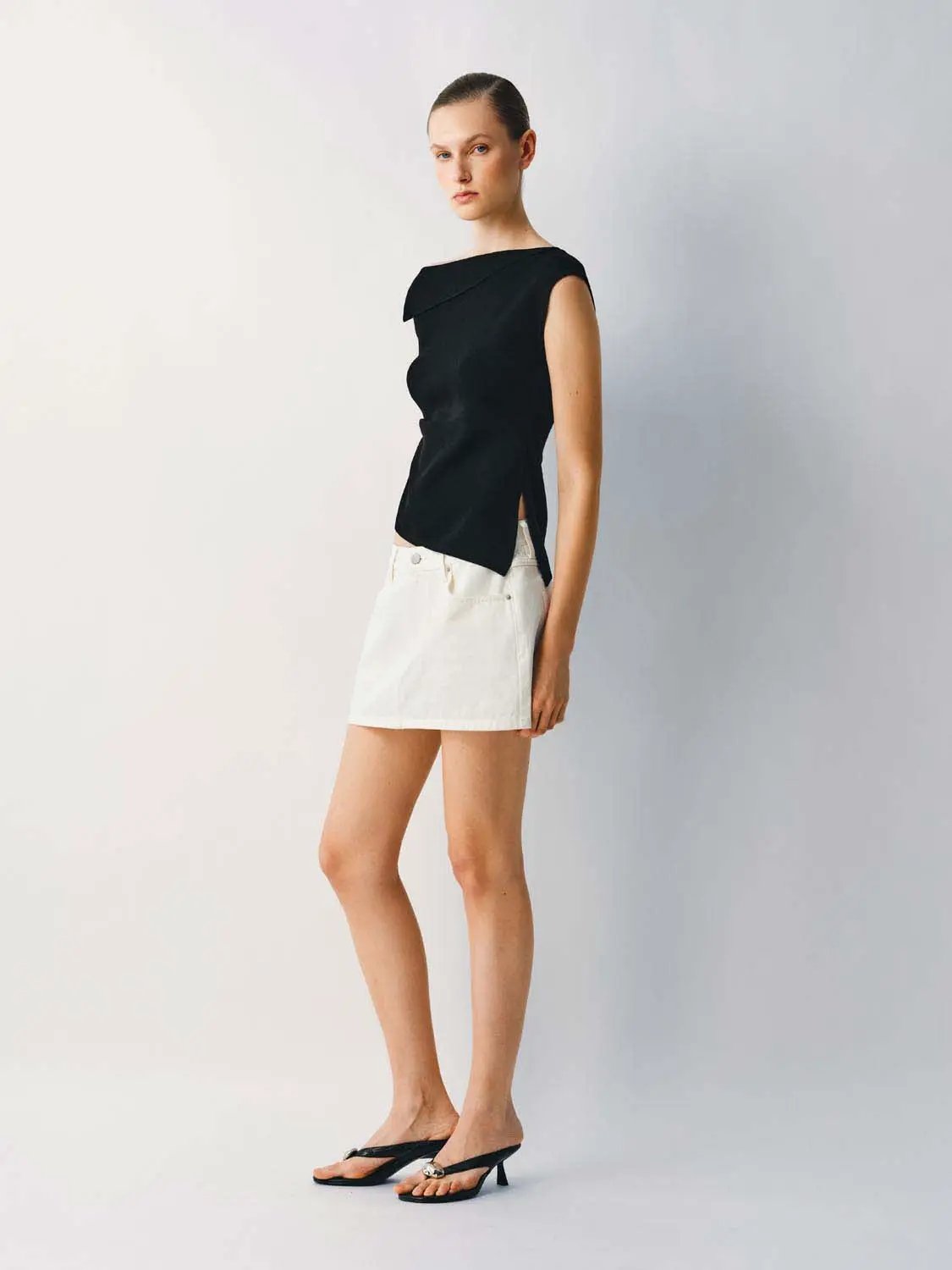 Medium Stretch T-Shirt, black knitted top by Urban Revivo Fashion on model; paired with white mini skirt.