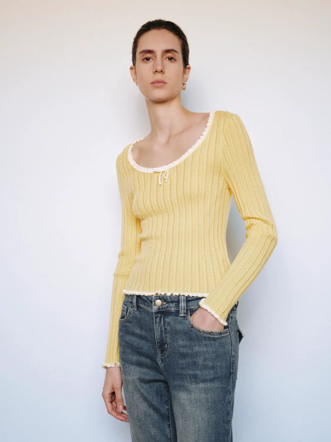 Ribbed square-neck long-sleeve knit T-shirt in yellow with bow at neckline and white trim.