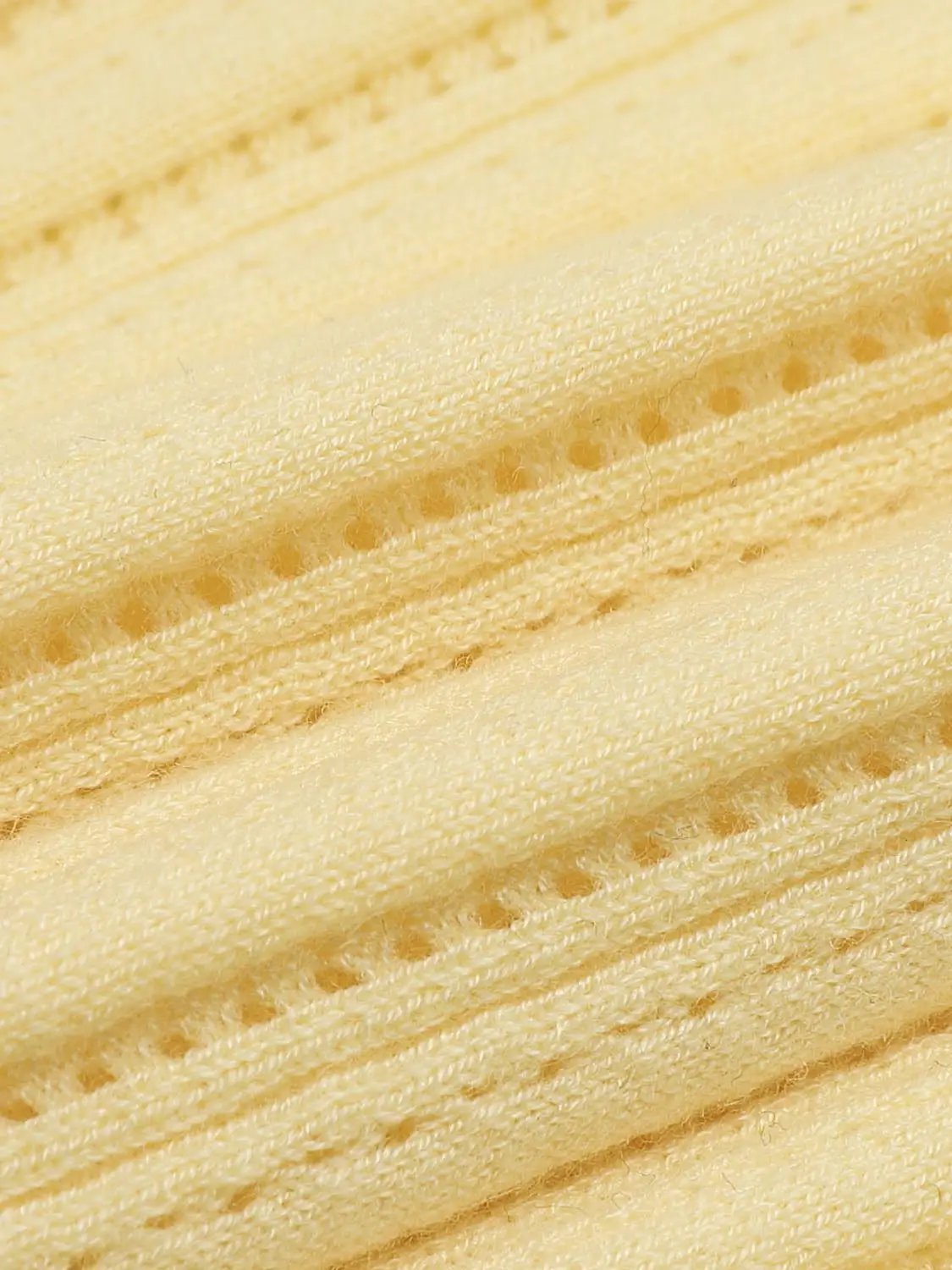 Ribbed yellow knit T-shirt fabric close-up showing textured yarn.