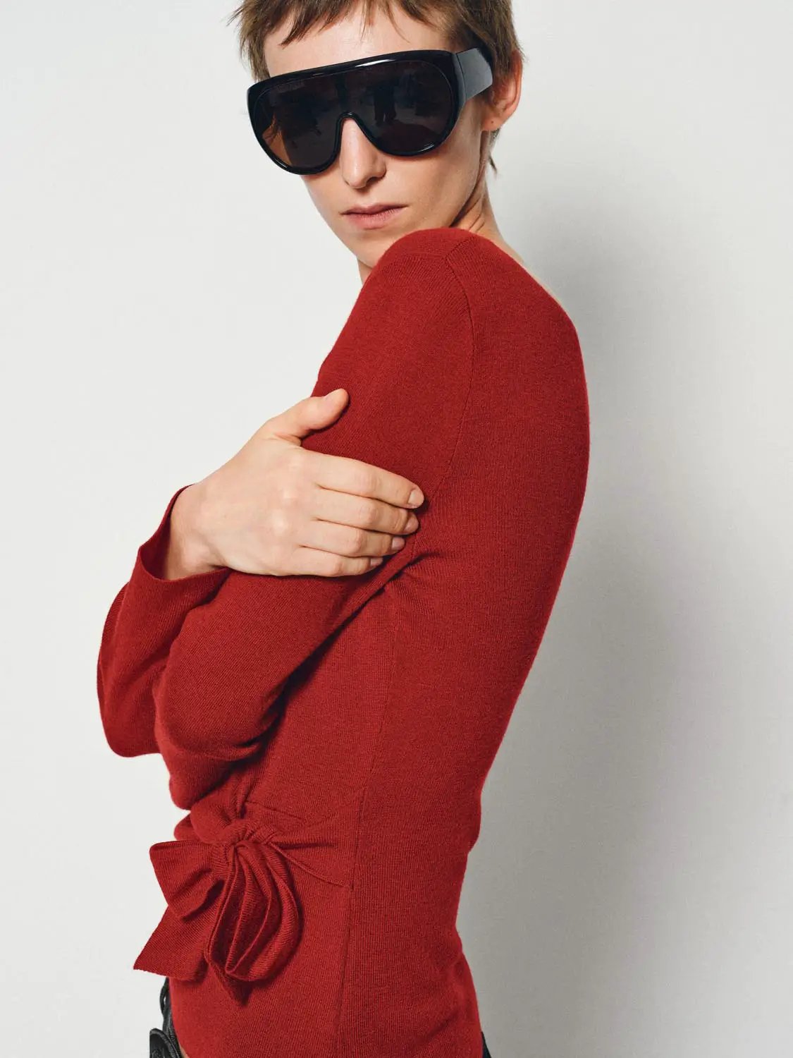 Ribbed long sleeve boat-neck tie-waist knit top in red.