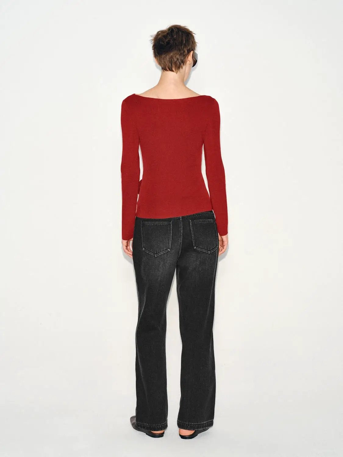 Ribbed long-sleeve boat-neck knit top in red, fitted silhouette.