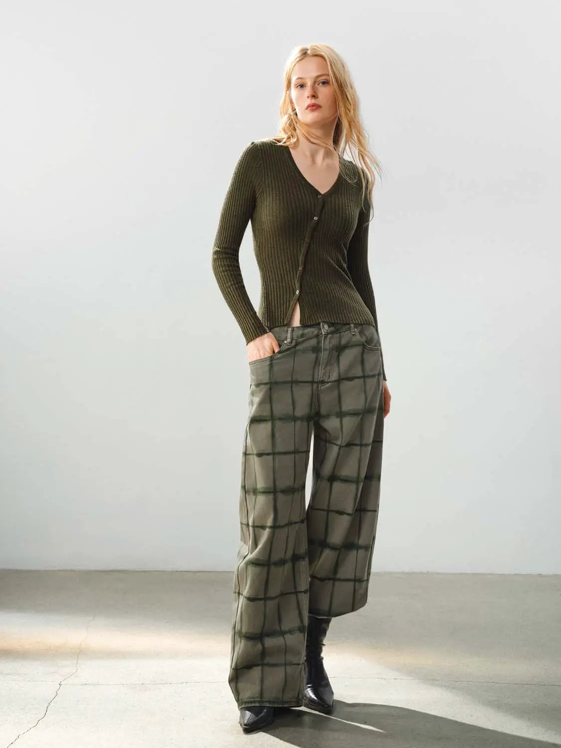 Fitted ribbed knit V-neck cardigan in olive green; paired with olive plaid wide-leg trousers (2-piece outfit).