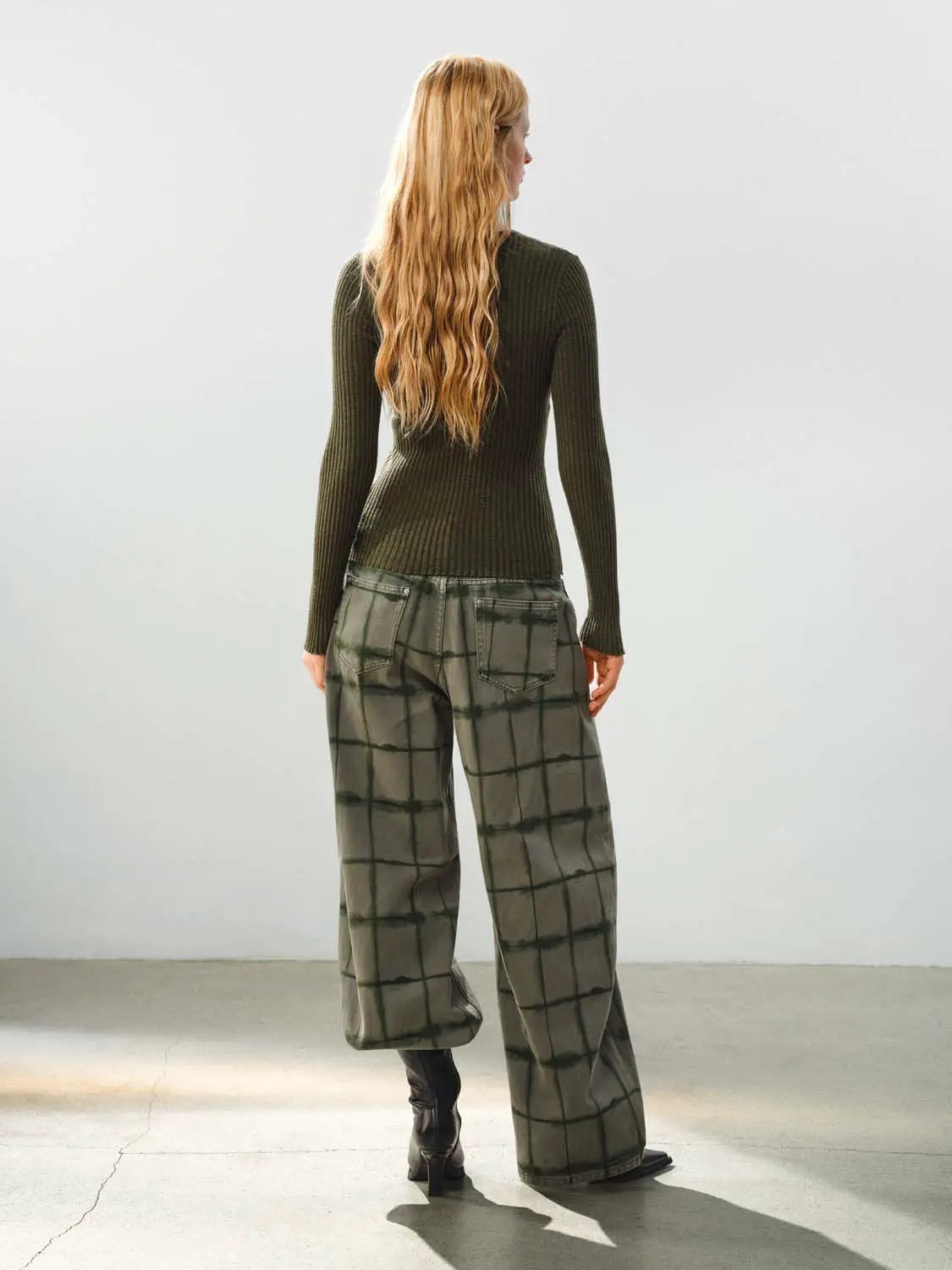 Fitted ribbed knit V-neck cardigan, olive green; two-piece set with green plaid wide-leg pants.