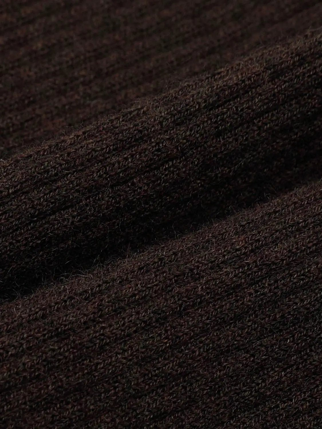 Knitted cardigan fabric in dark brown with soft, fuzzy texture