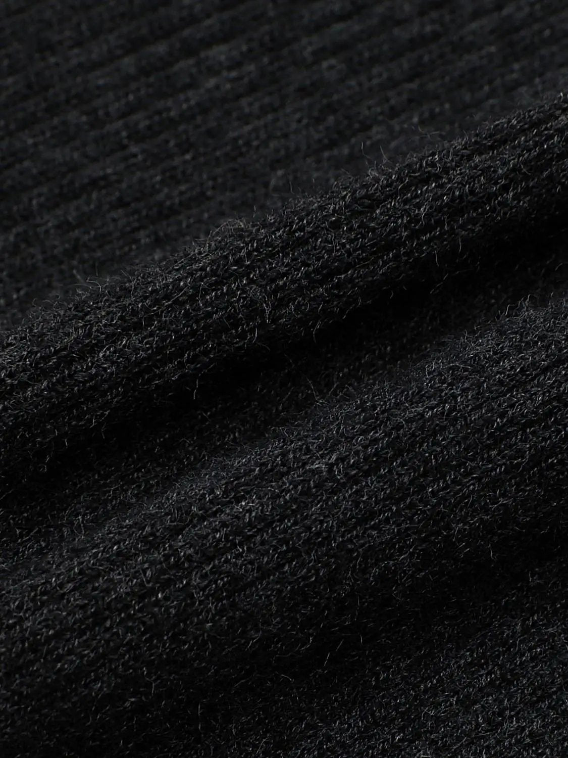 Ribbed slim mock-neck knitted cardigan in black fabric close-up
