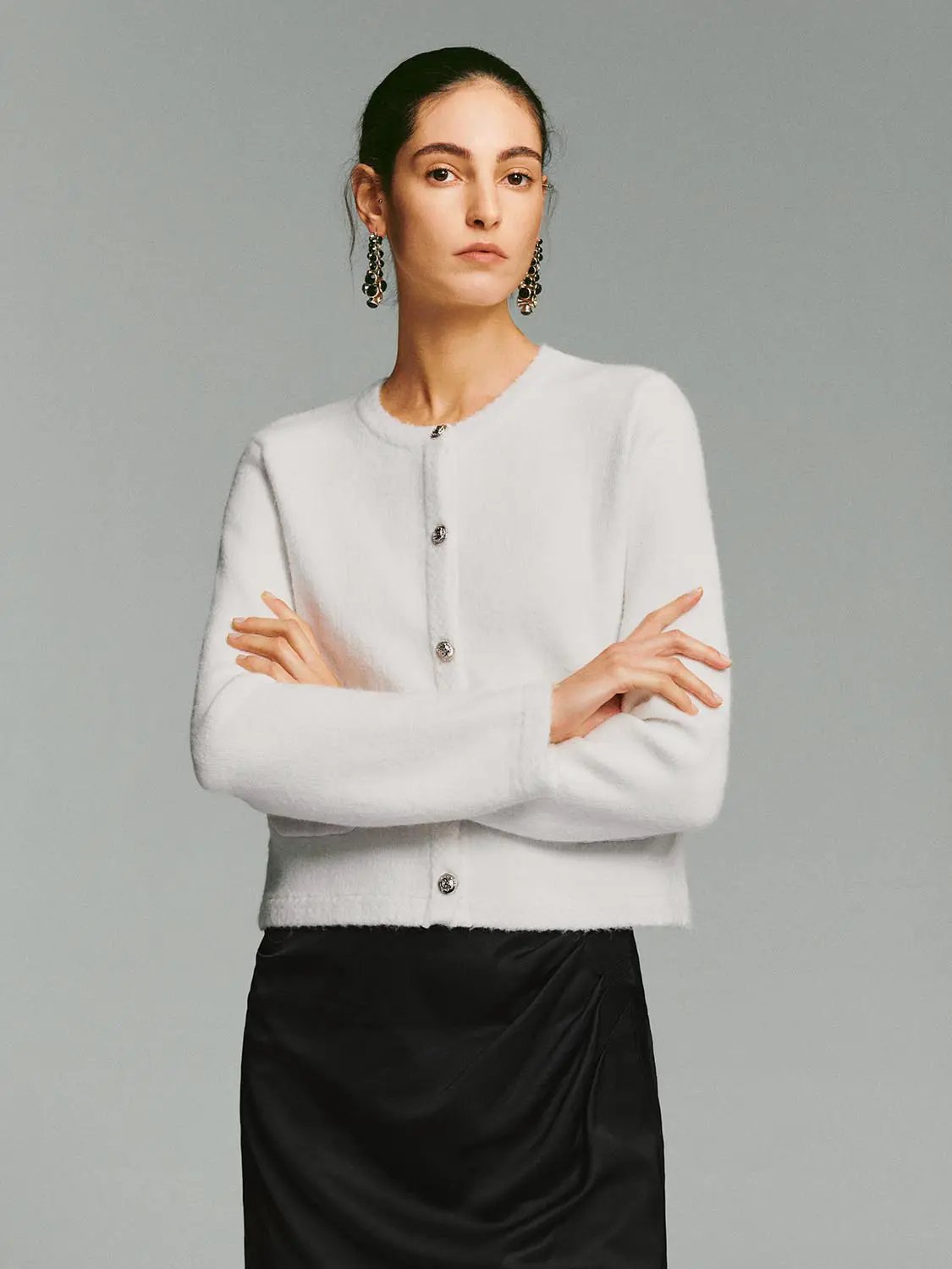 White crew-neck knit cardigan with button-front closure, long sleeves, cropped hem
