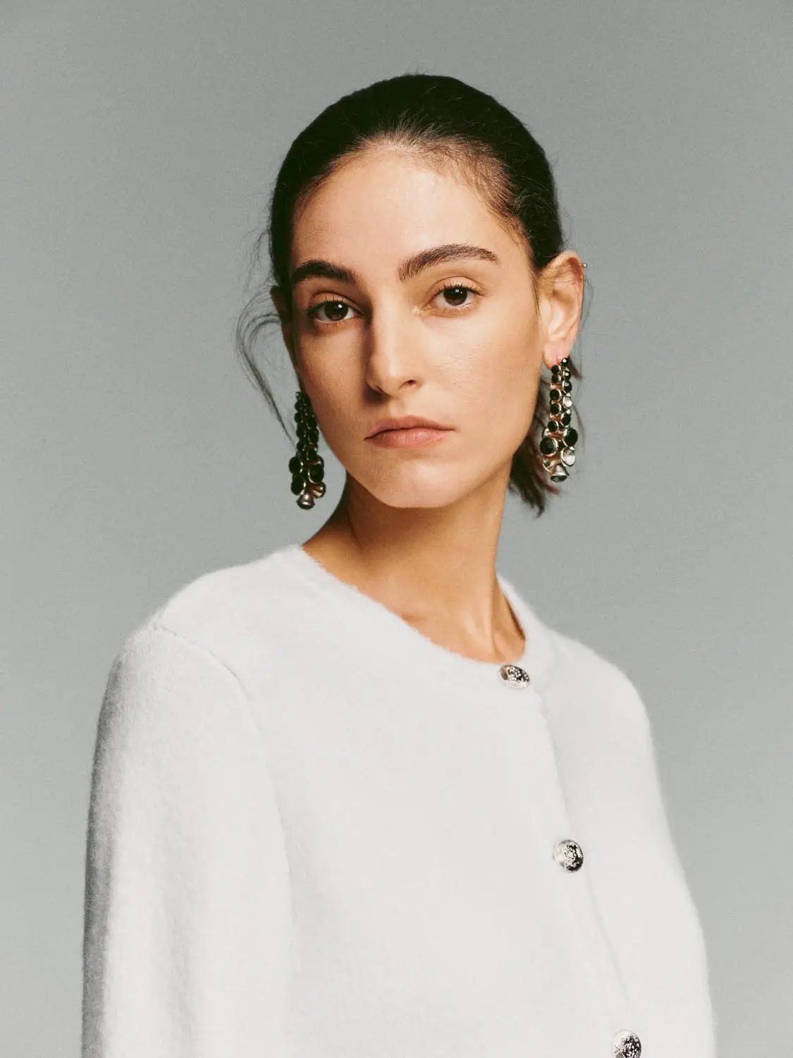 White crew-neck knit cardigan with button-front closure and long sleeves