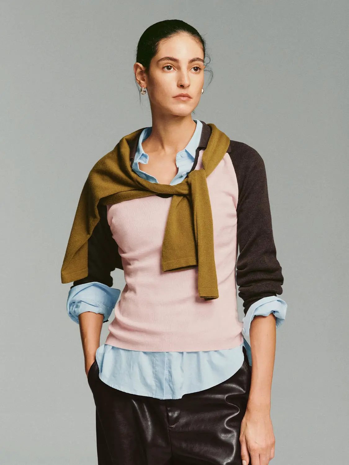 Fitted two-tone v-neck collared long-sleeve knit top, pink body with dark brown sleeves.