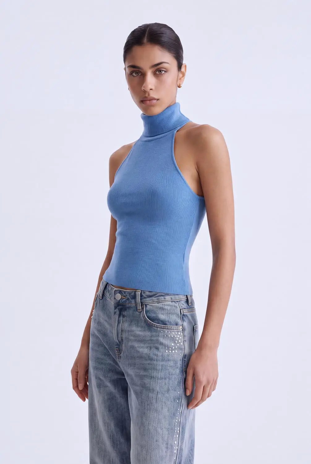 Knit sleeveless turtleneck top in blue; ribbed knit fabric