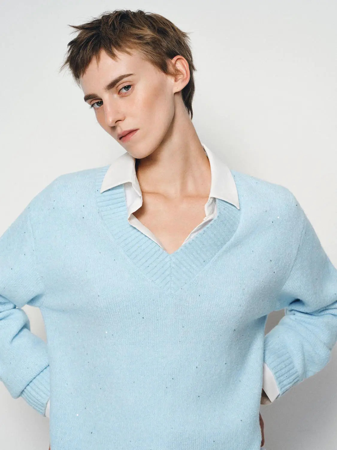 Knit T-Shirt in light blue with white collared shirt underneath, V-neck knit.
