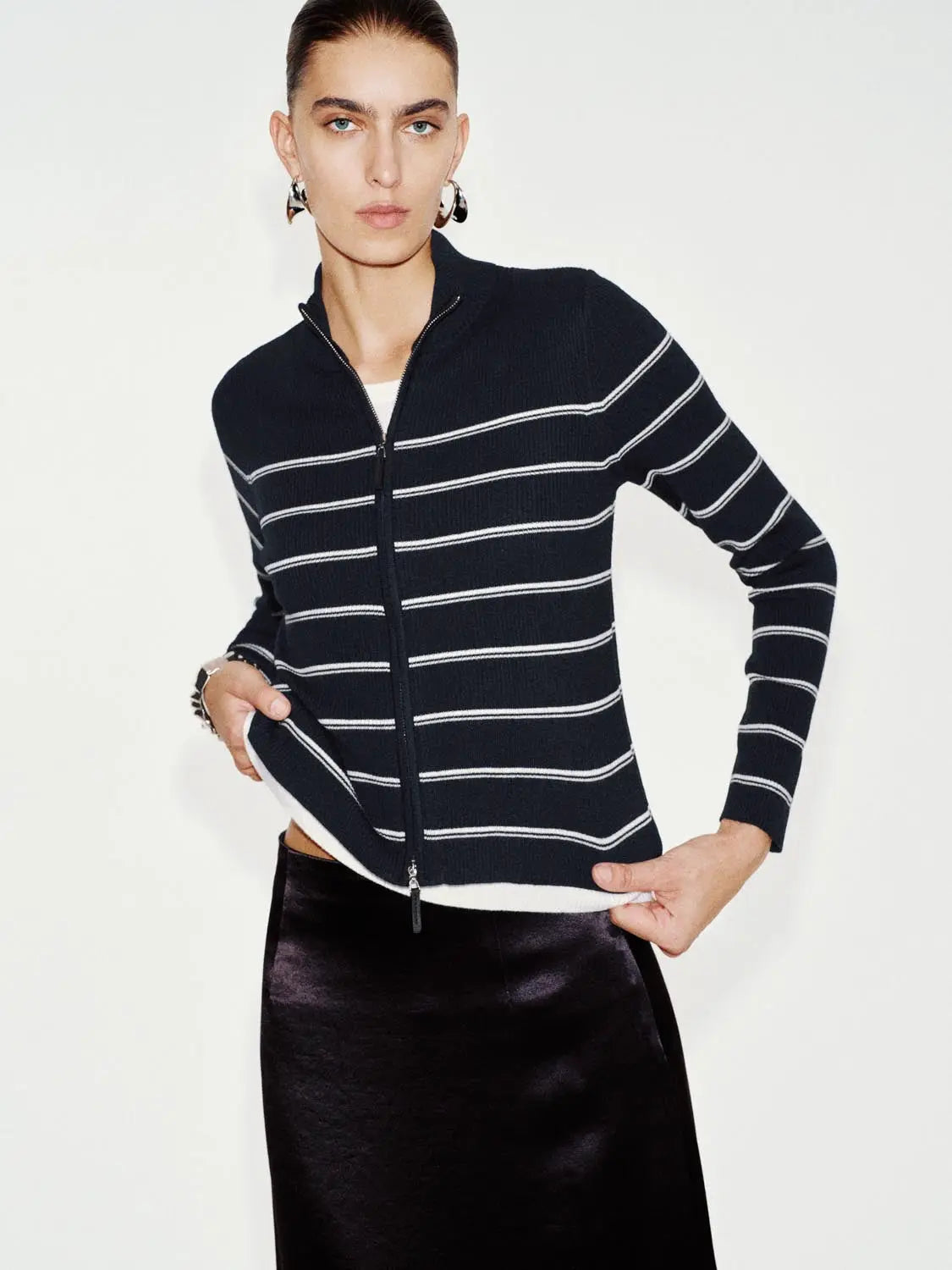 Knit jacket in navy with white horizontal stripes; zip-front cardigan.
