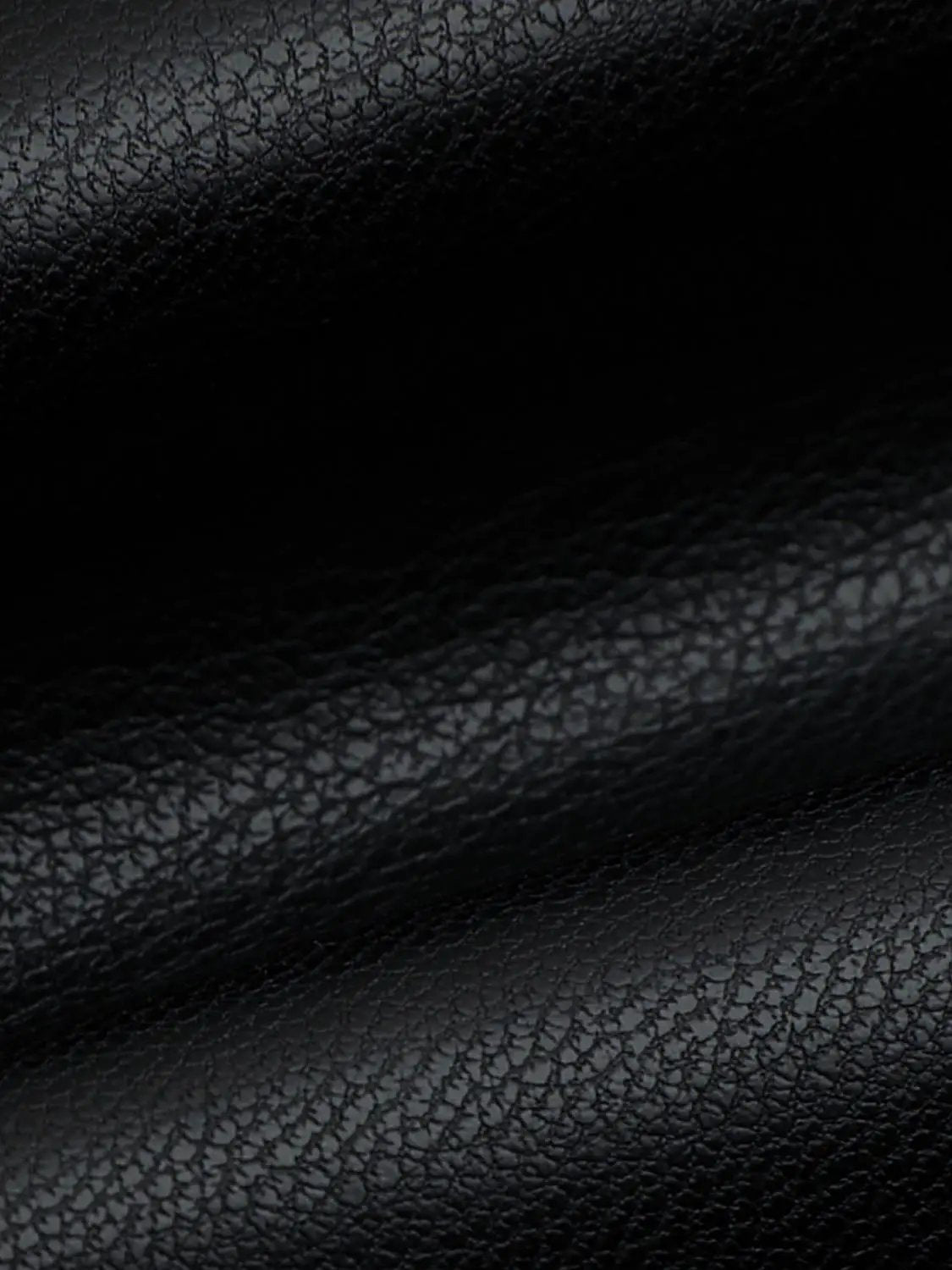 Pleated vegan leather A-line skirt in black with pebbled texture