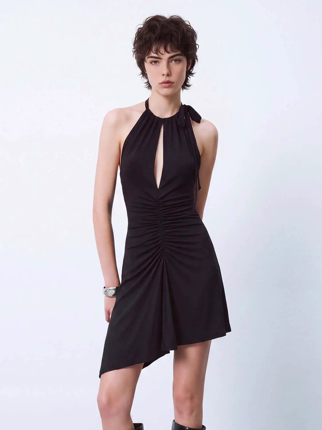A-Line dress in black with halter neck, ruched front and front slit.