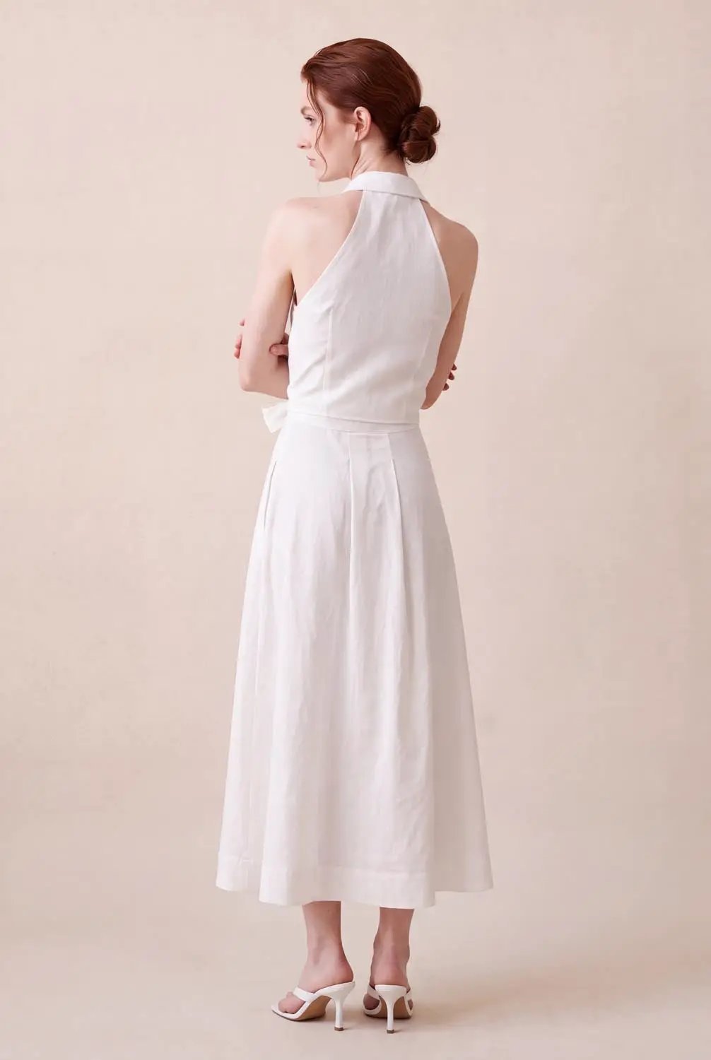 A-Line Dress, white sleeveless halter-neck with waist bow, midi length.
