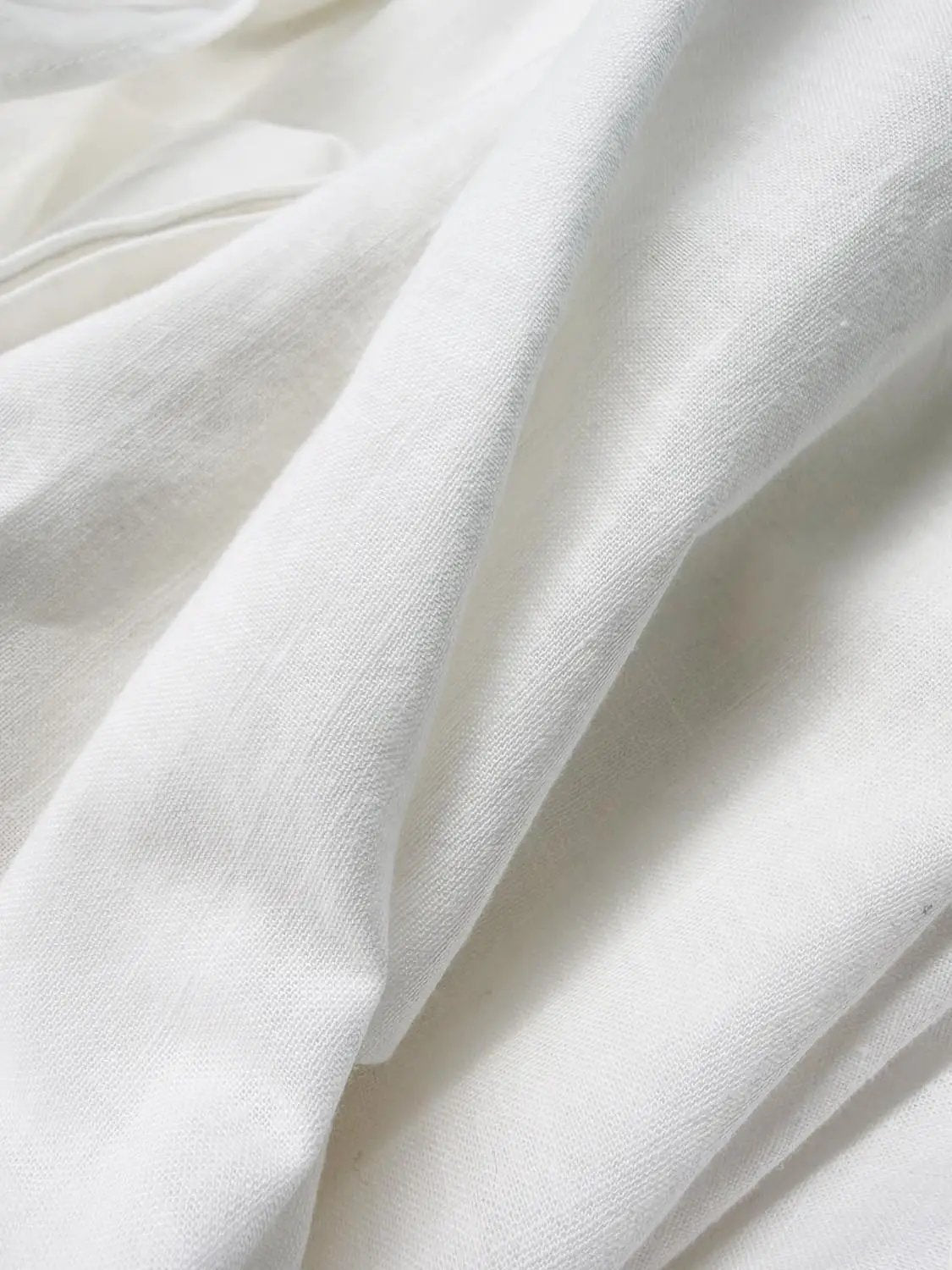 A-Line Dress white fabric close-up with soft draped folds and woven texture