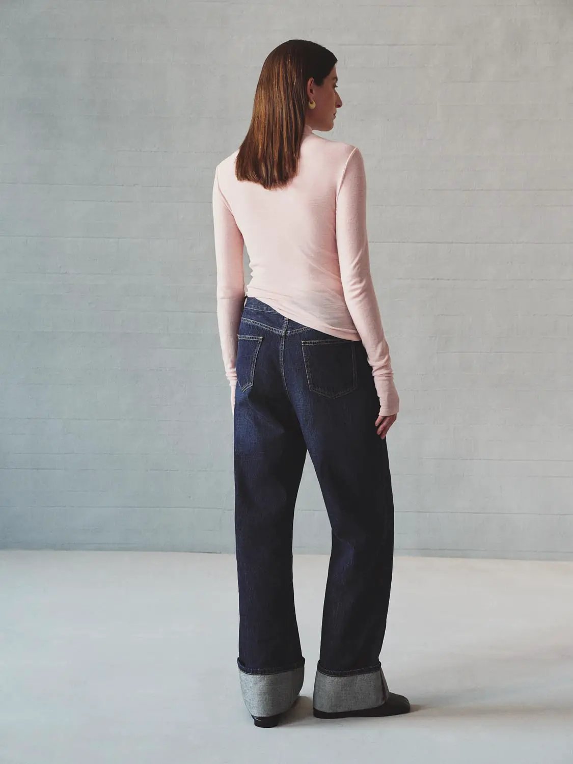 Jeans by Urban Revivo Fashion in dark indigo denim with rolled cuffs, back view