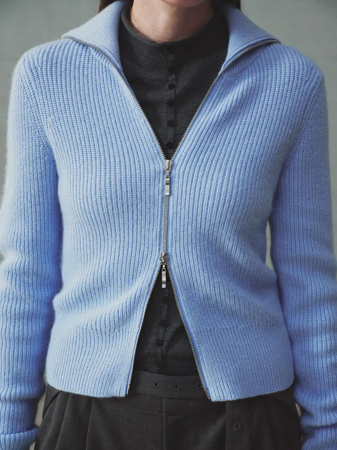 Knit jacket in light blue with zip-front closure, knitted cardigan style.