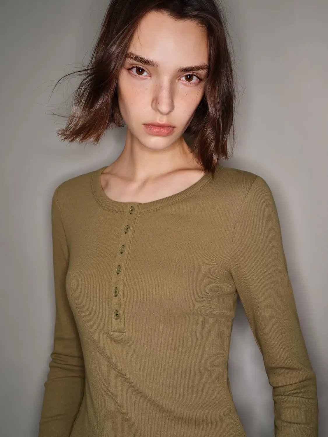 T-shirt, khaki ribbed long-sleeve henley with button placket.