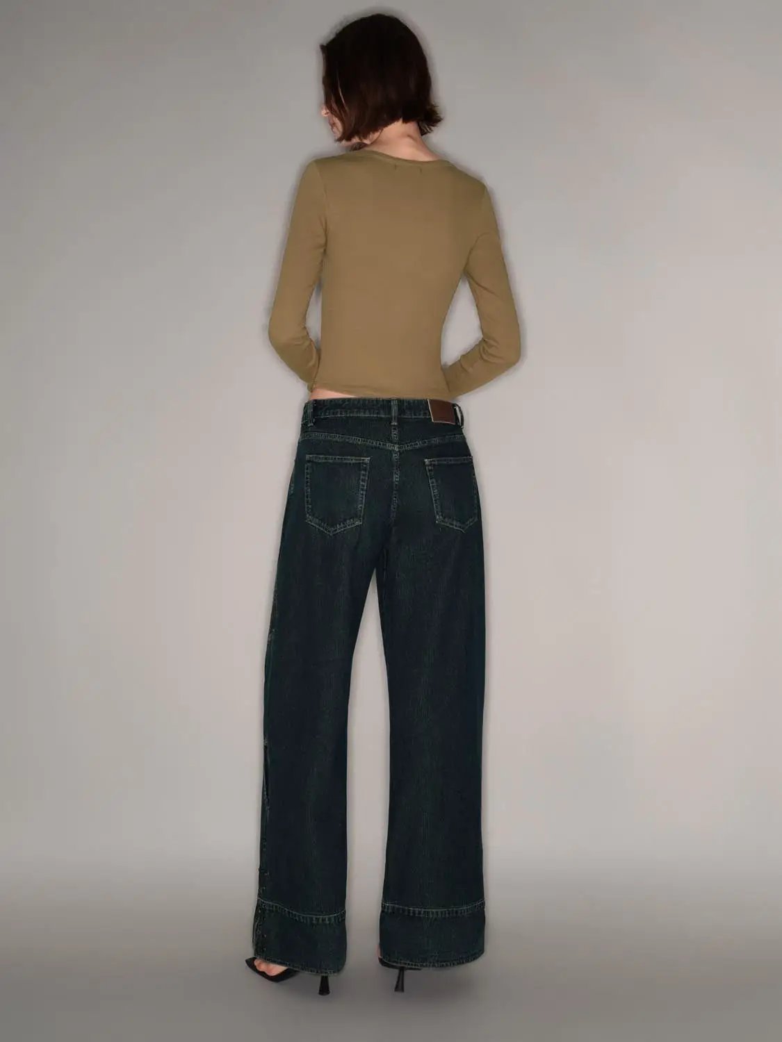 T-Shirt by Urban Revivo Fashion in tan, long-sleeve, shown from the back with dark wide-leg jeans.
