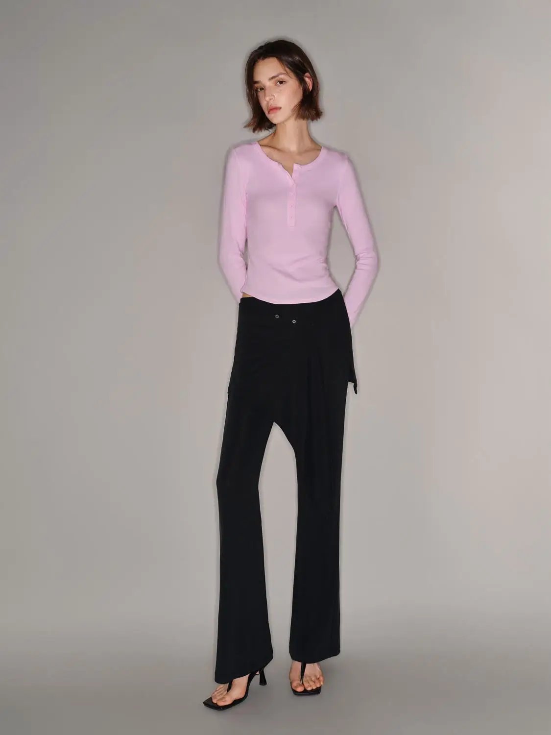 T-shirt by Urban Revivo Fashion; pink long-sleeve with button placket on a model wearing black wide-leg pants.