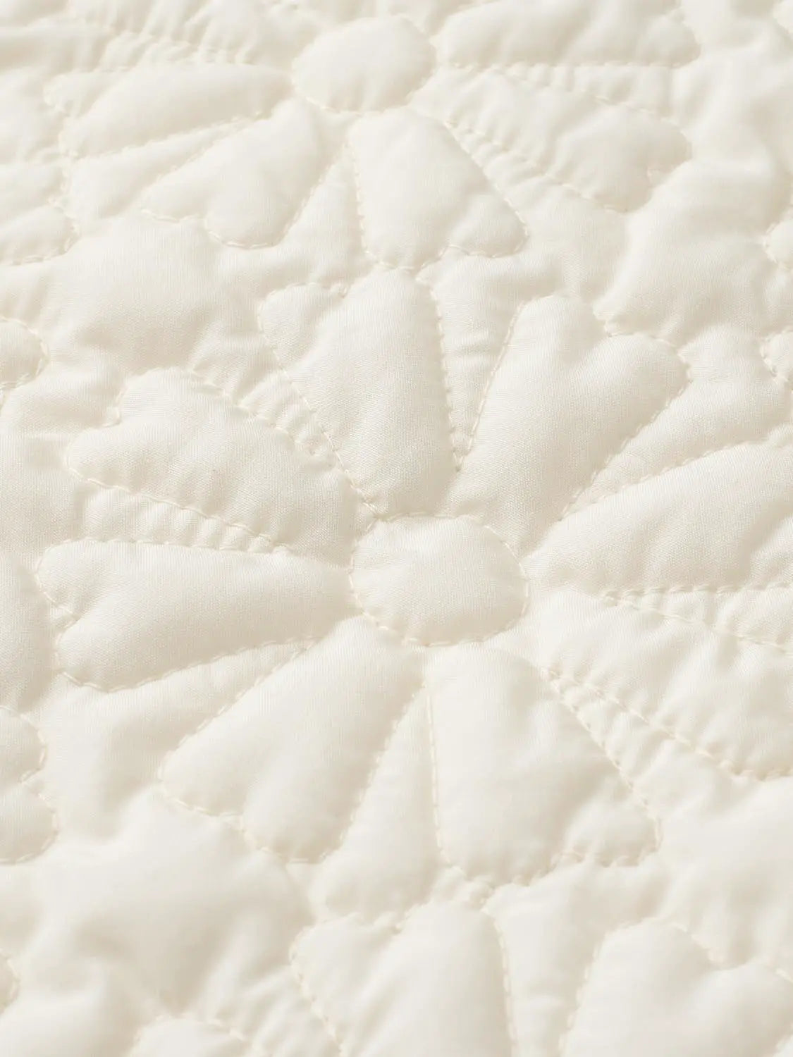 Padded jacket in cream with flower-shaped quilted stitching