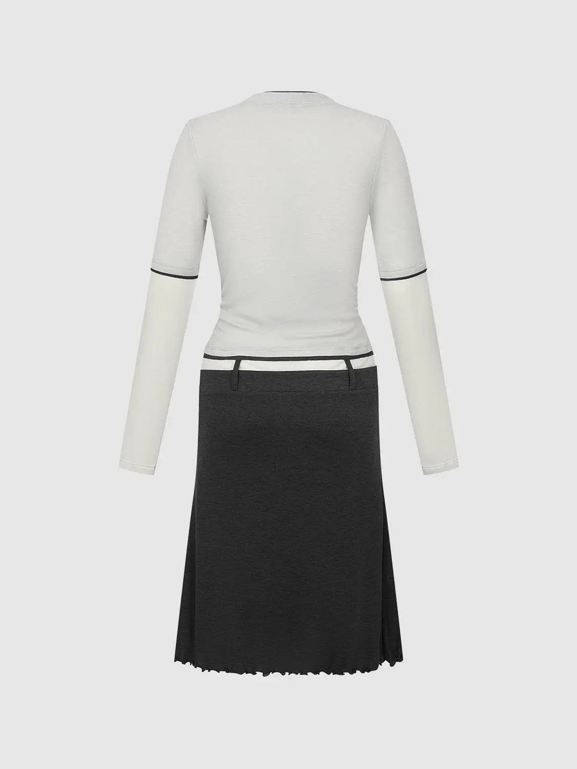 2-In-1 contrast trim crew-neck knit top with cream body and black sleeve bands, paired with a dark skirt