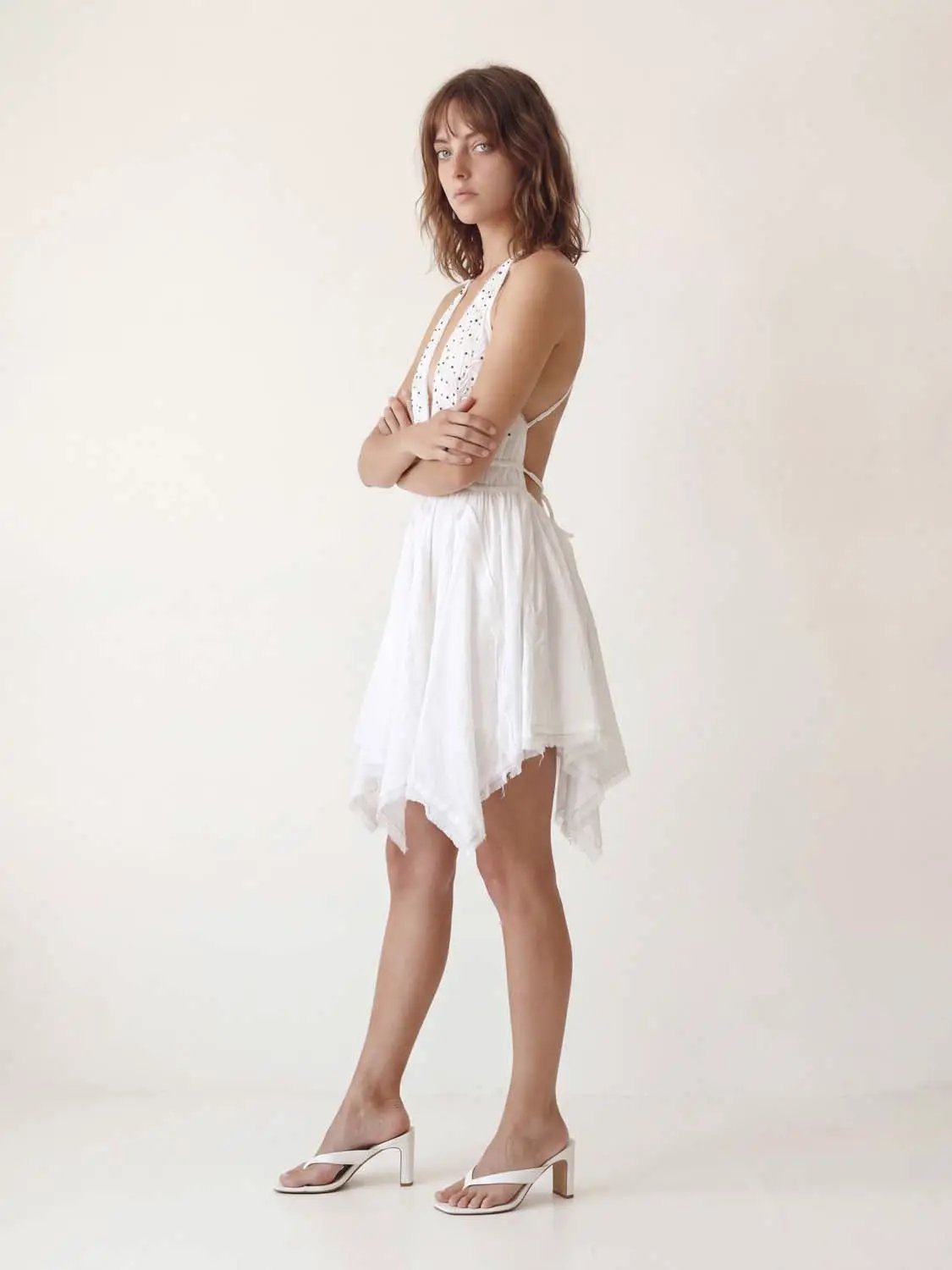 A-Line dress, white, halter neckline with open back and high-low hem.