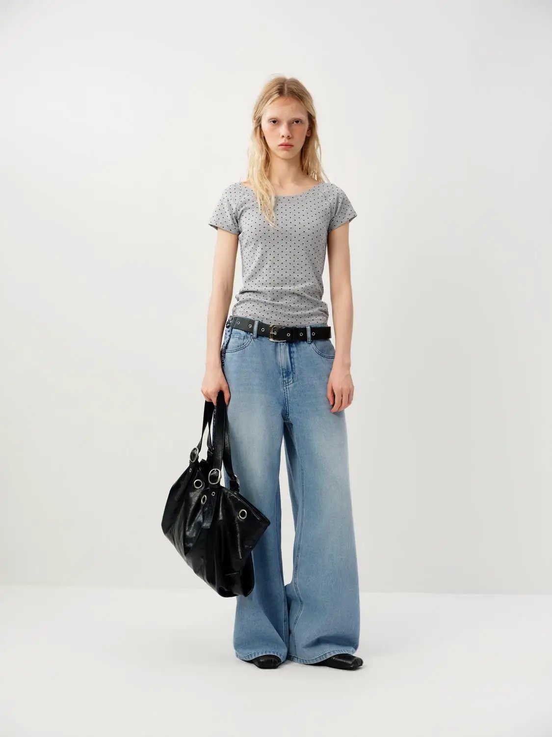 Wide-leg cotton jeans with decorative patch detail in light-wash blue.