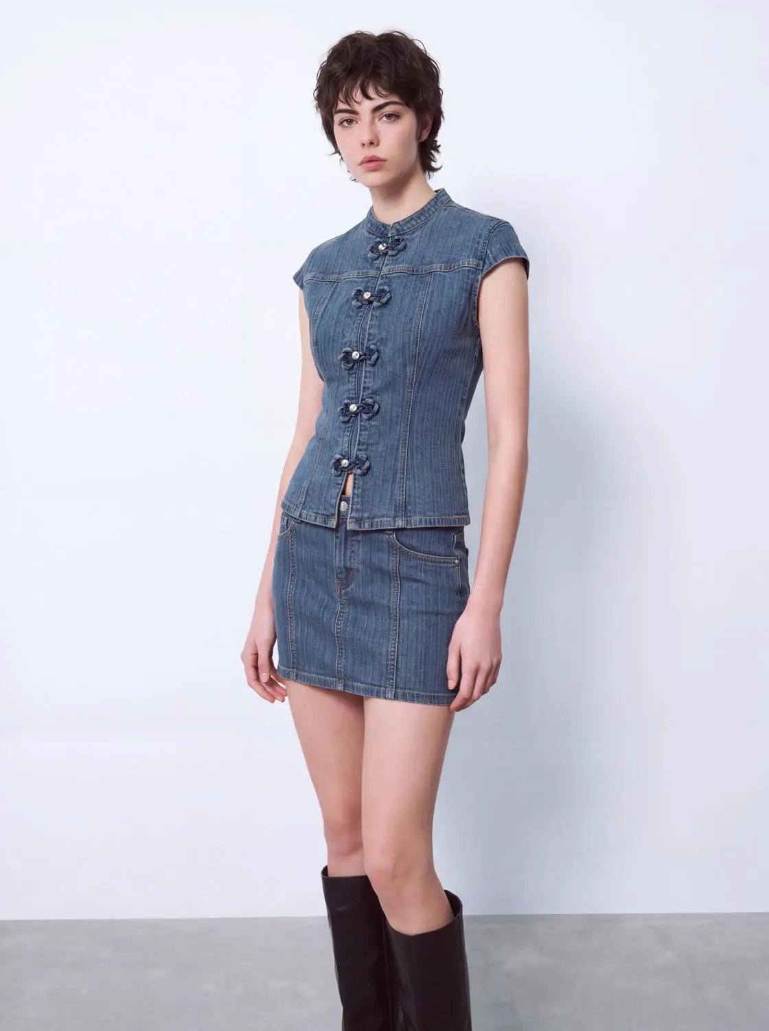 Denim shirt top with cap sleeves and front knot closures in blue, paired with a matching denim mini skirt