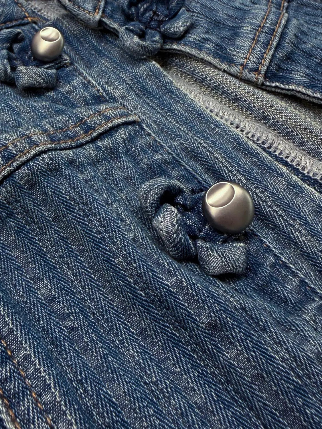Denim shirt by Urban Revivo Fashion; close-up of blue denim fabric with metal buttons.