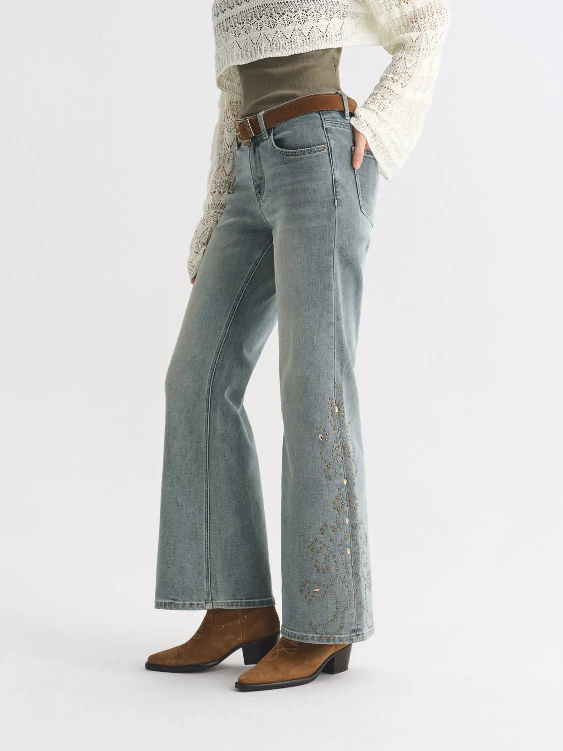Jeans light-wash denim with wide-leg silhouette and floral embroidery on the lower leg; brown belt shown