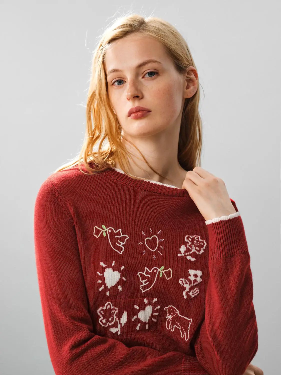 Knitwear T-shirt in red with white motif patterns and white trim at neckline and cuffs.