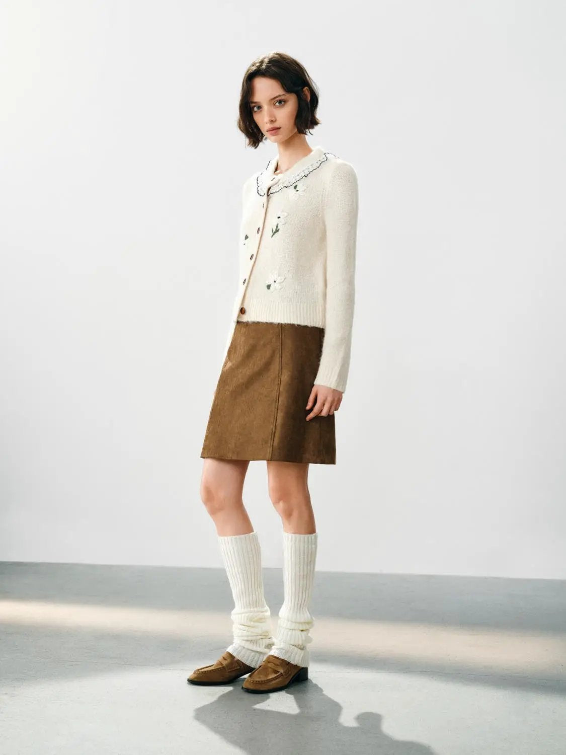Floral embroidered ivory knitted cardigan with a ruffle collar and long sleeves