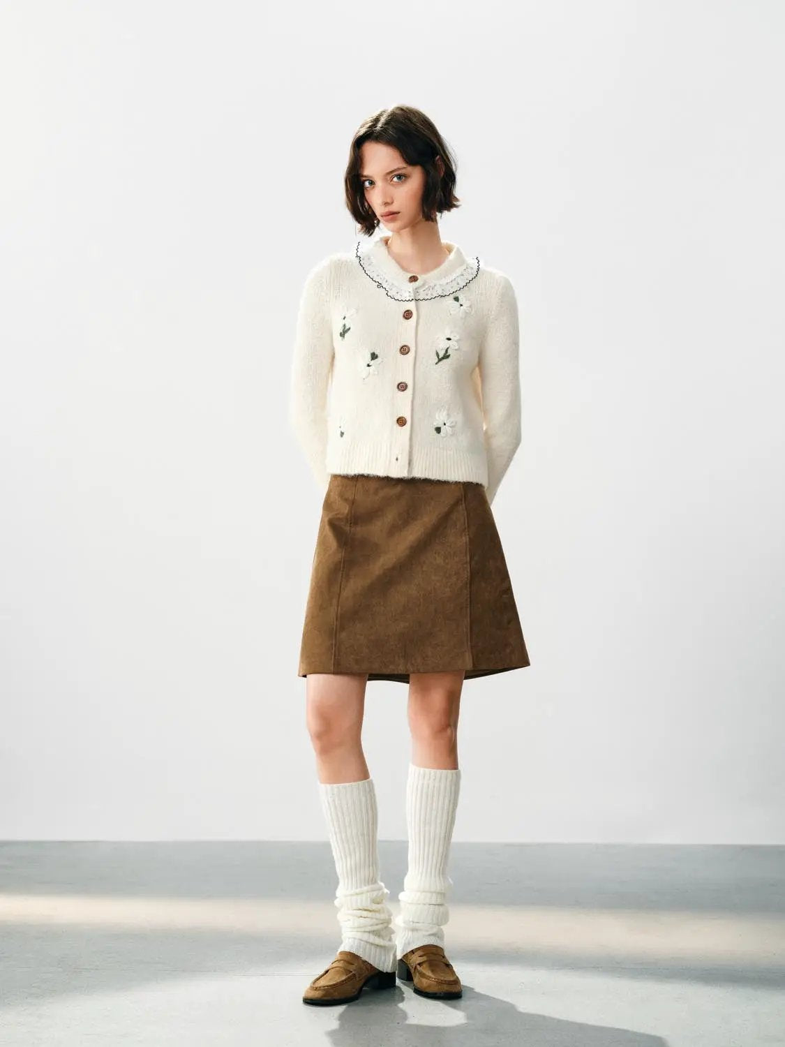 Floral Embroidered Ruffle Collar Cardigan in cream; knitted with long sleeves and brown buttons