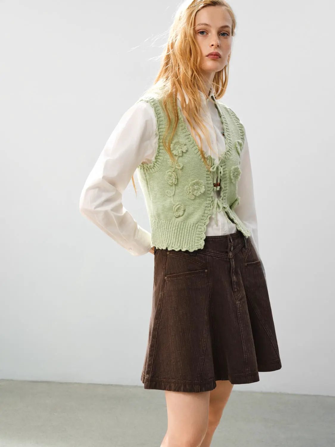 Floral Ruffle Tie V-neck Sleeveless Cotton Vest, mint green with tie-front details worn over a white shirt.