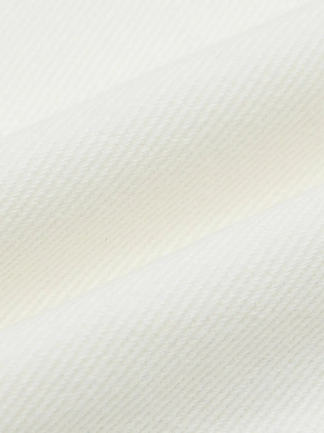 Casual jeans in white denim fabric, close-up texture