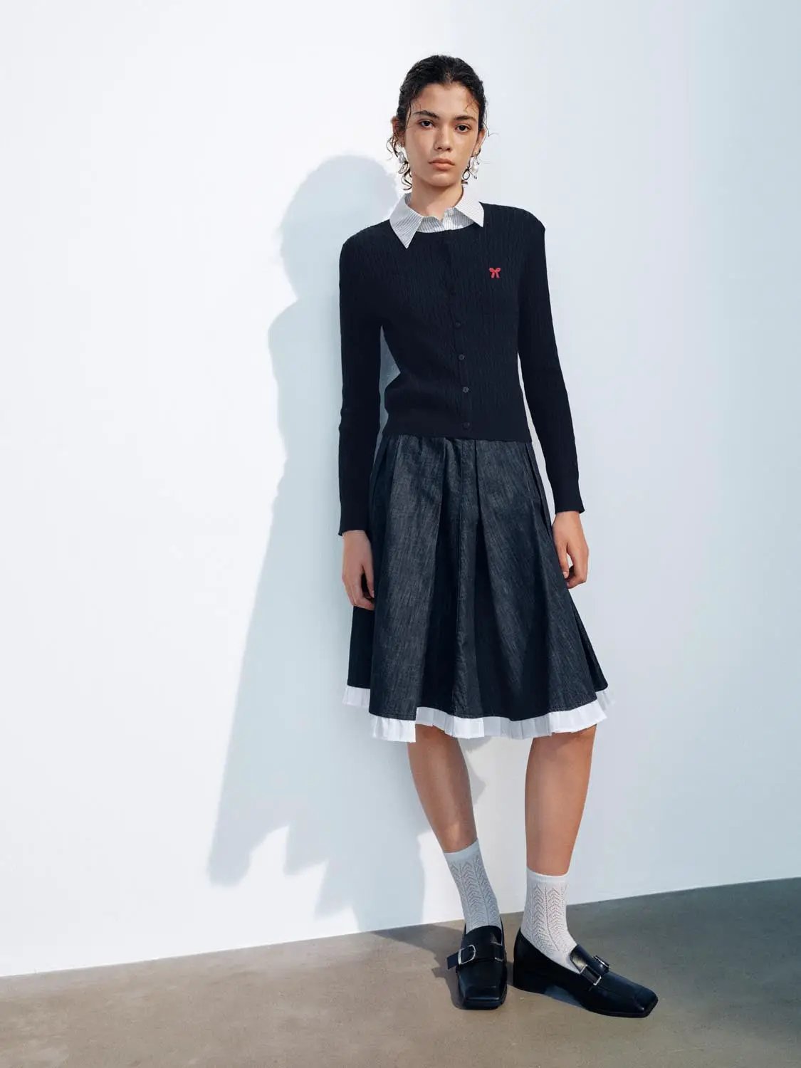 Knit cardigan by Urban Revivo Fashion; navy knit with button-front, white collar shirt, dark midi skirt.