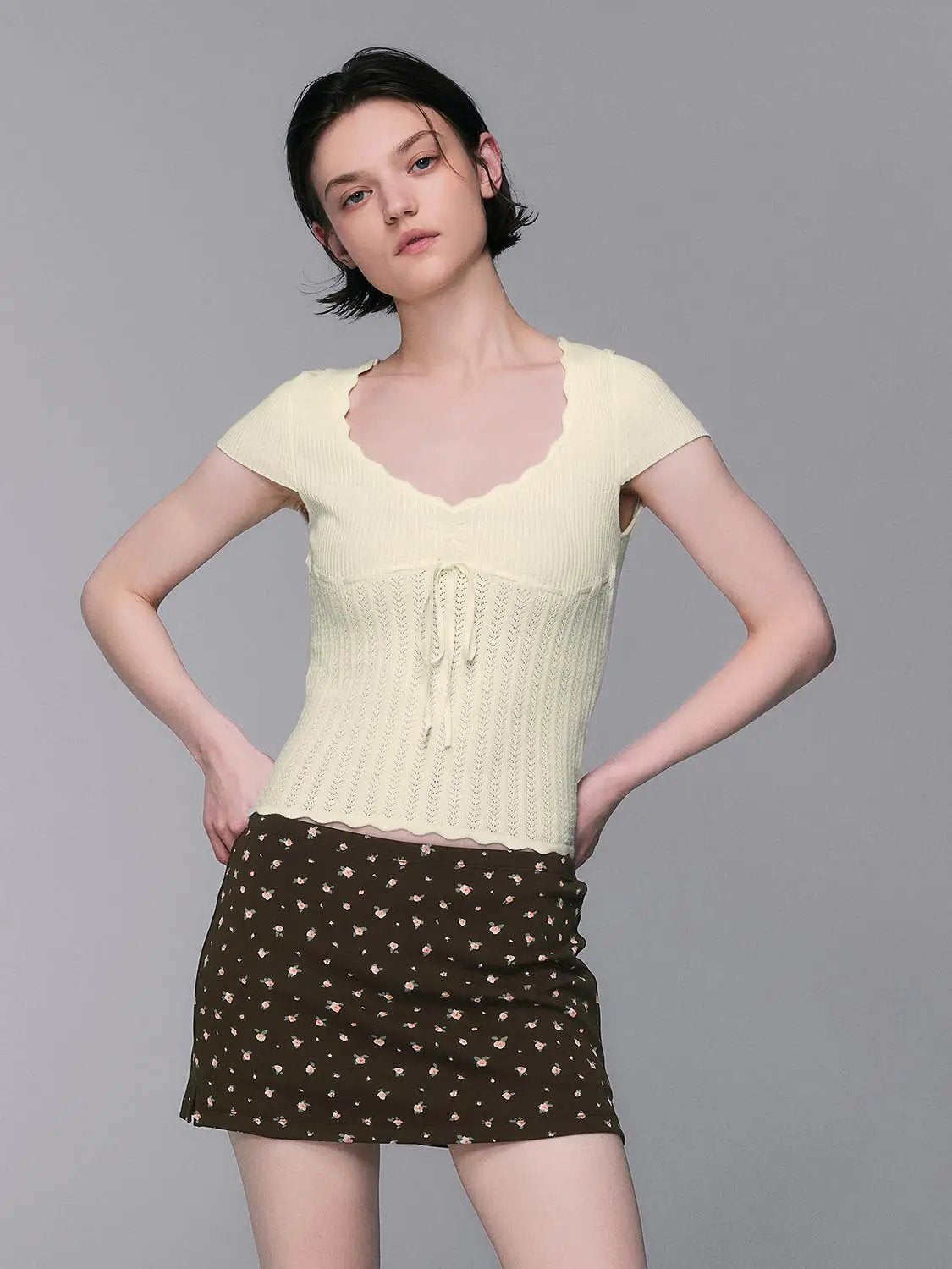 Knit Soft V-neck Scalloped Lace Lightweight Blouse, cream knit with tie-front; paired with brown floral mini skirt.