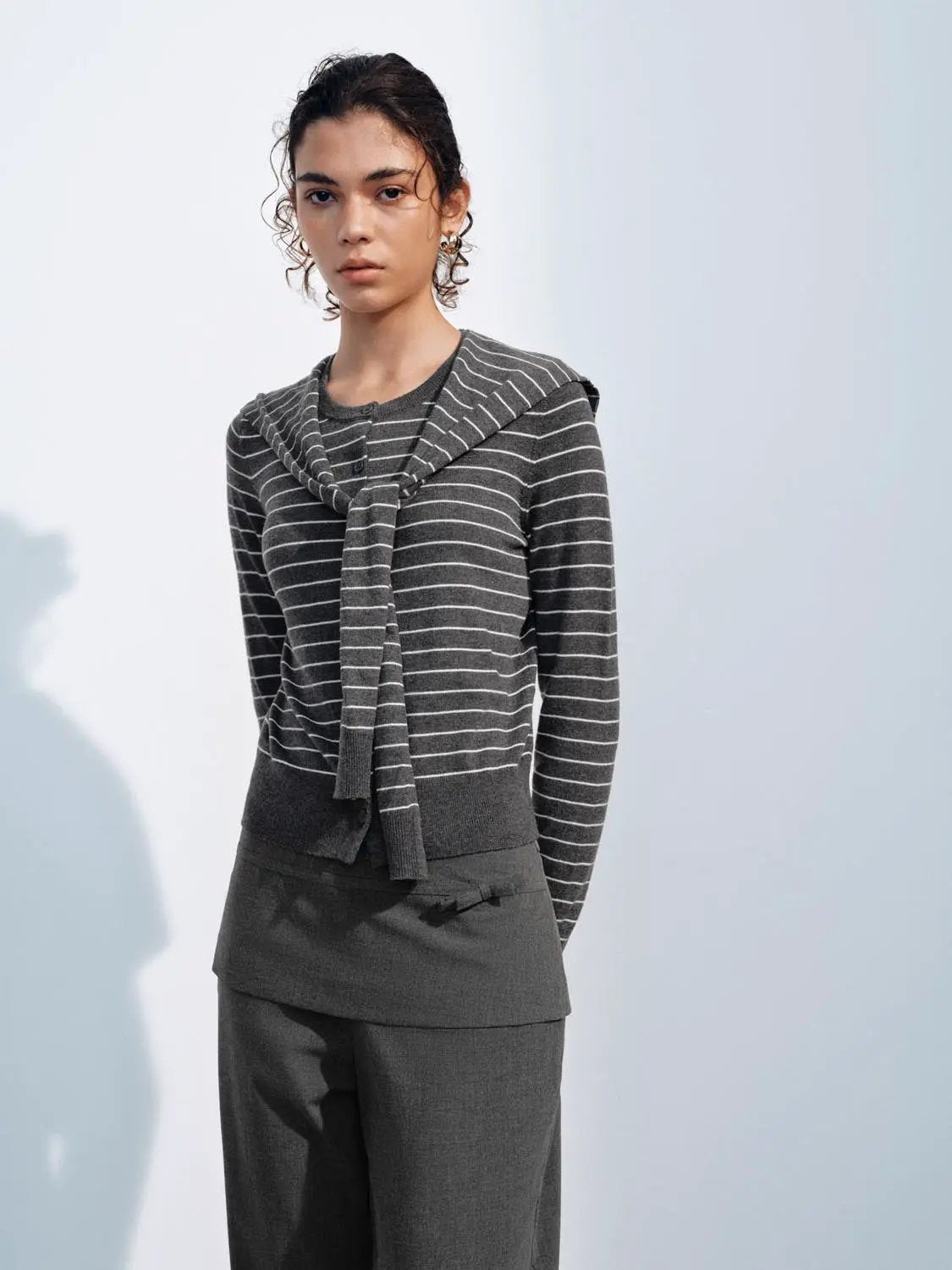 Knit jacket in dark gray with white horizontal stripes and a scarf-like front tie.