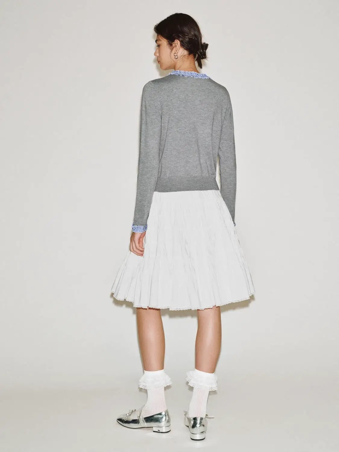 Knitted cardigan in grey by Urban Revivo Fashion, paired with a white pleated skirt.
