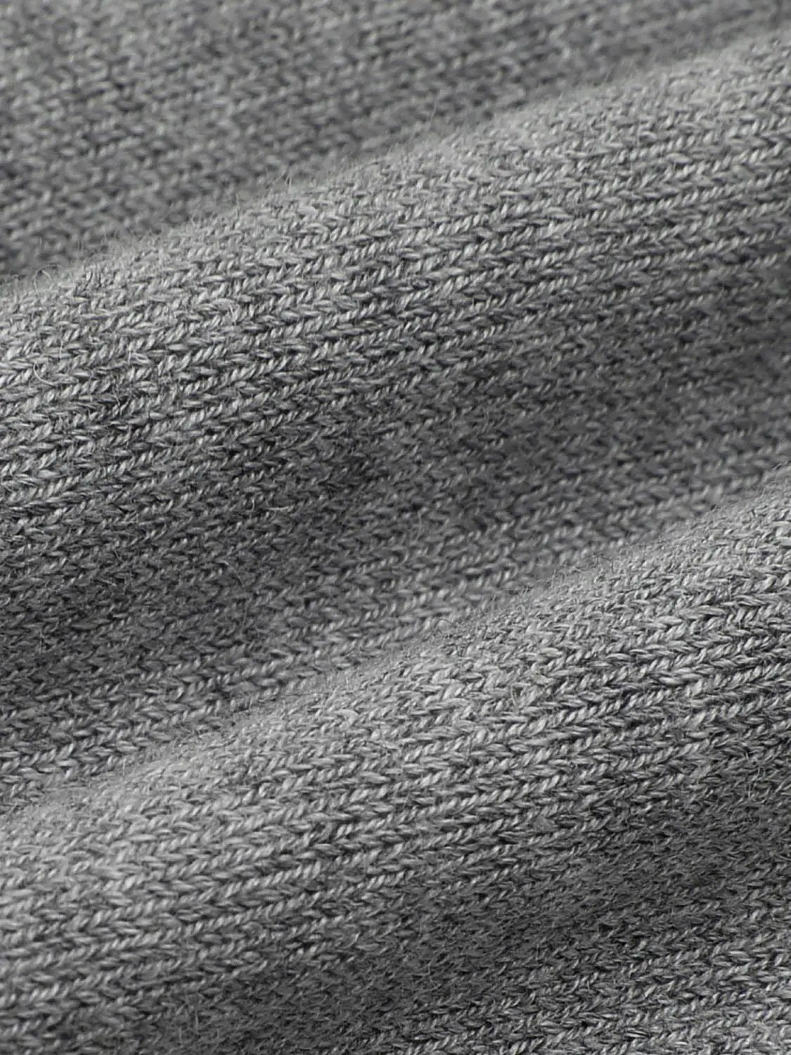 Knitted jacket fabric close-up in gray knit texture