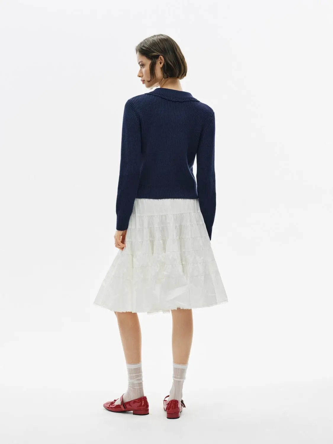 Knitwear Jacket by Urban Revivo Fashion in navy knit, shown on a model with a white tiered skirt.
