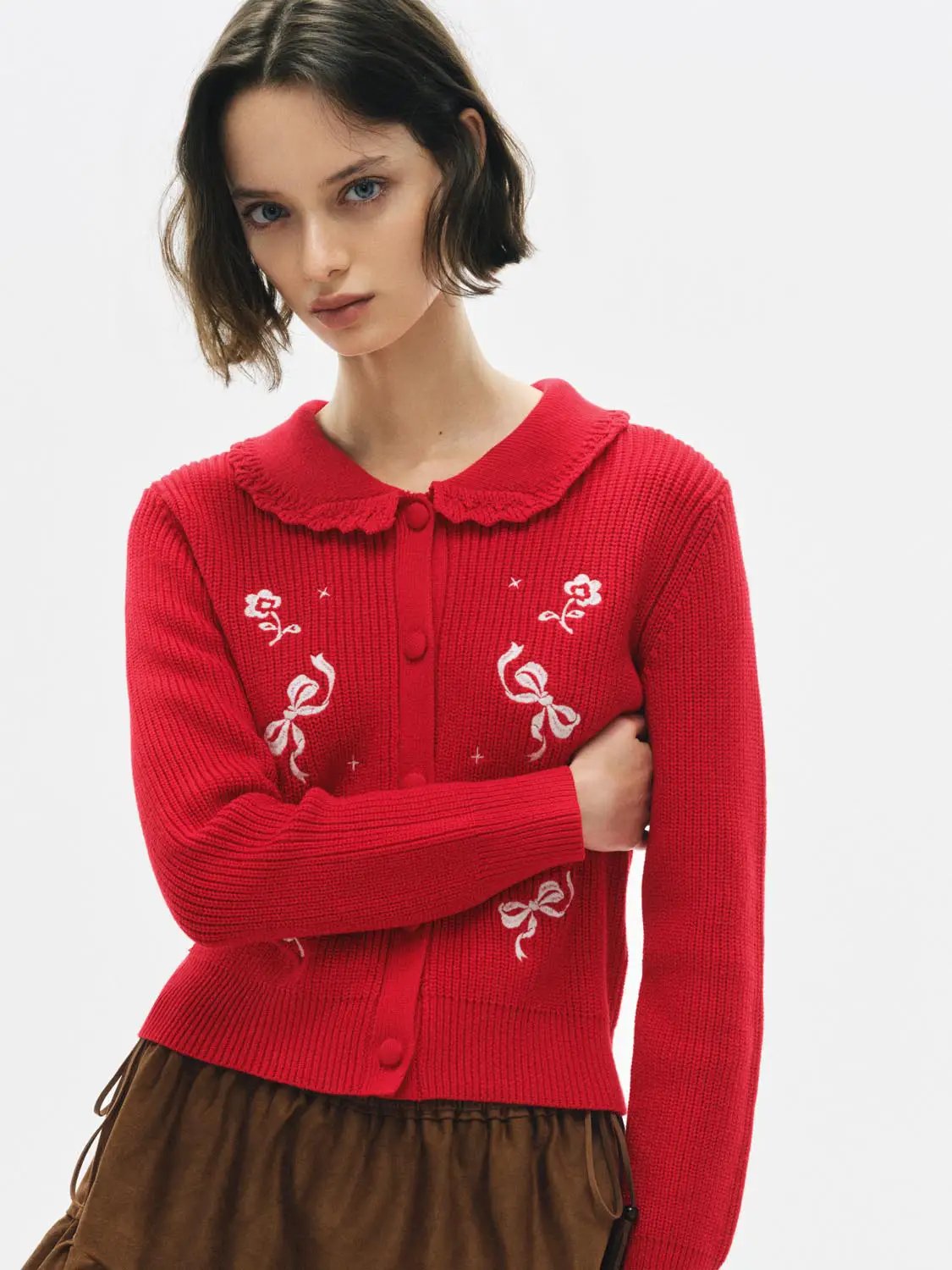 Knitted cardigan in red with white bow embroidery details