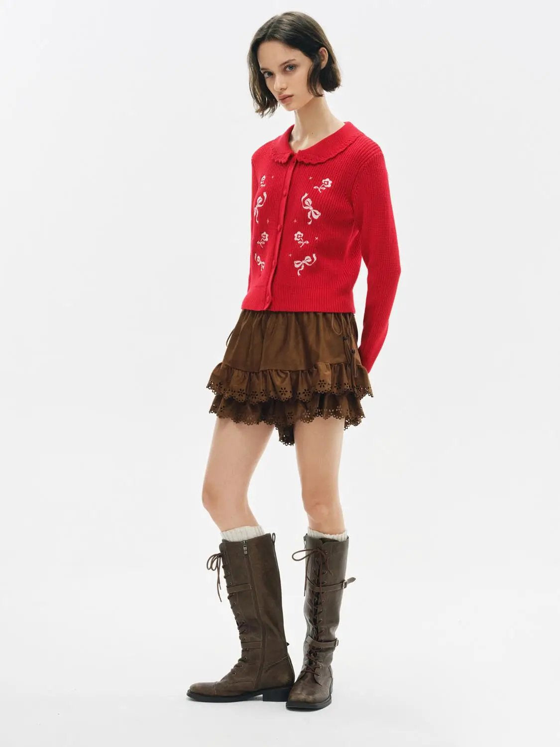 Red knit cardigan with white floral embroidery from Urban Revivo, paired with brown tiered skirt and knee-high boots.